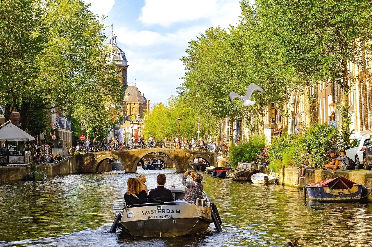 Boat cruising through a picturesque canal, surrounded by beautiful architecture and vibrant city life, creating a captivating scene of tourism and leisure
