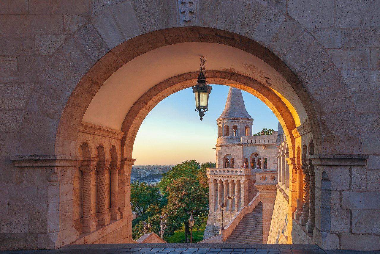 Stunning architecture of Budapest, Hungary, featuring a grand historic building with intricate details against a clear blue sky.