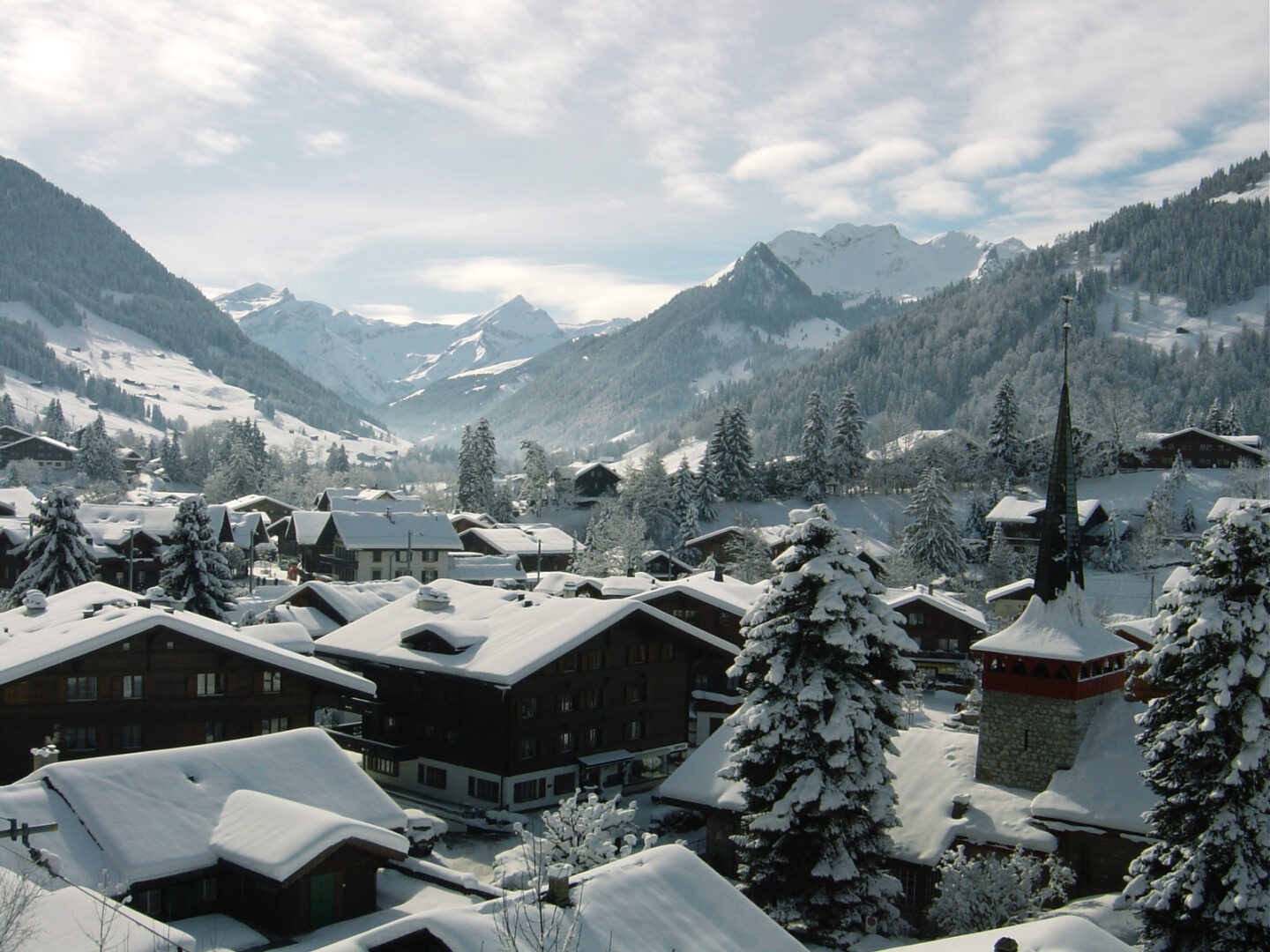 gstaad ski village in europe covered in snow with mountains in background