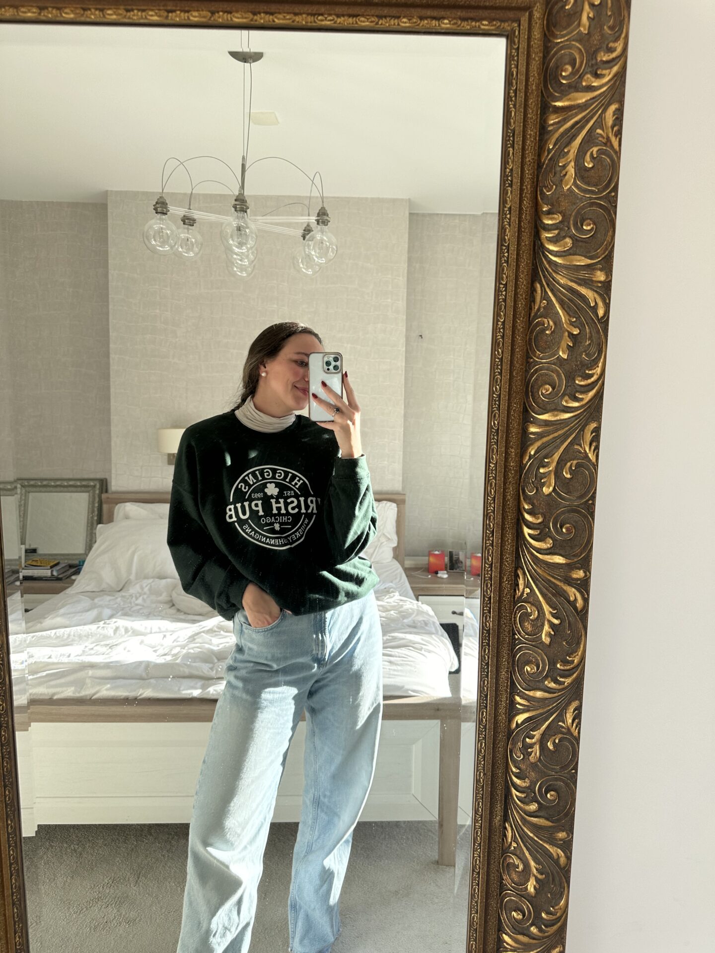 woman wearing green sweatshirt and jeans