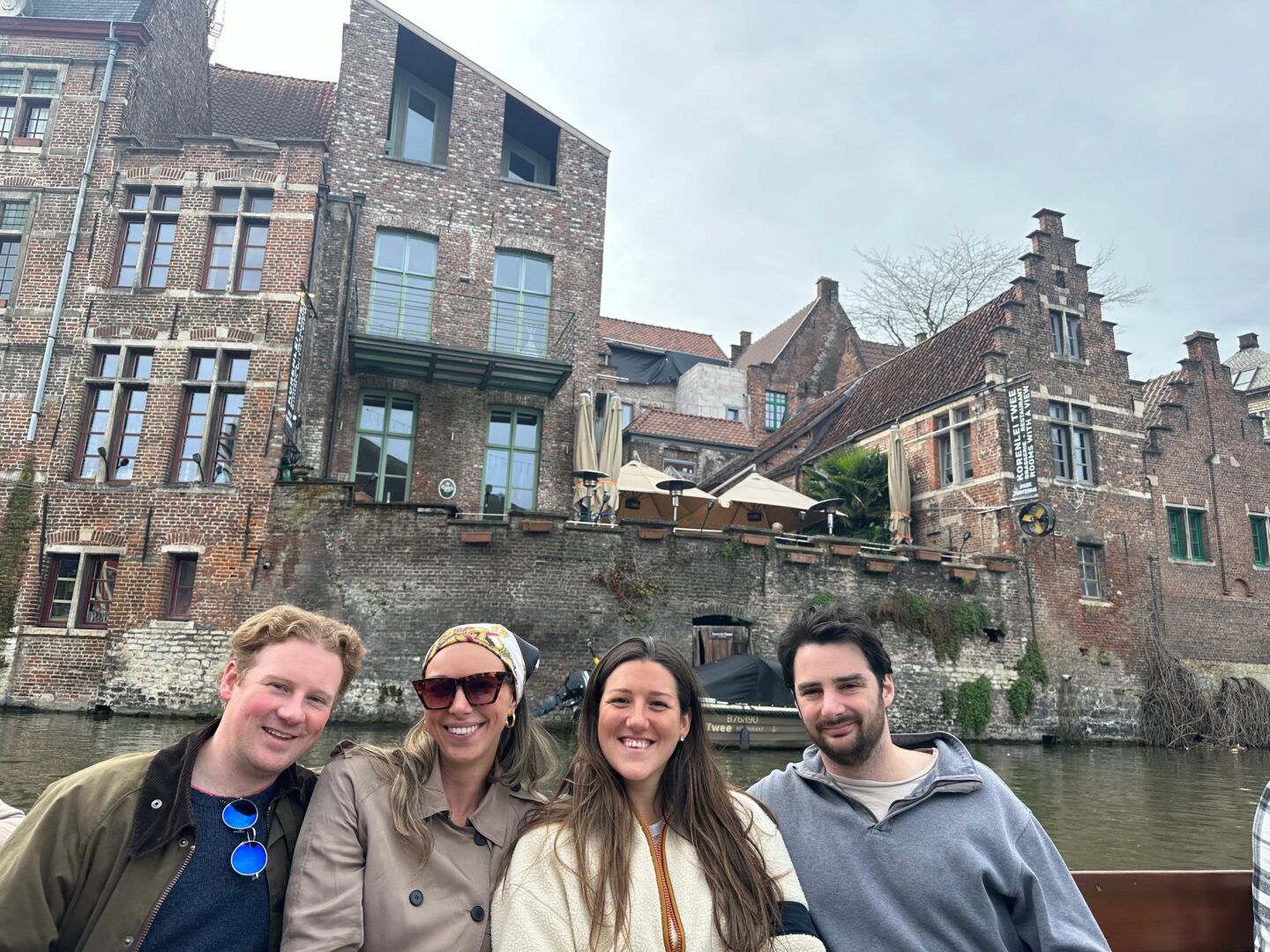 group of 4 people sitting on boat on river cruise in Ghent belgium