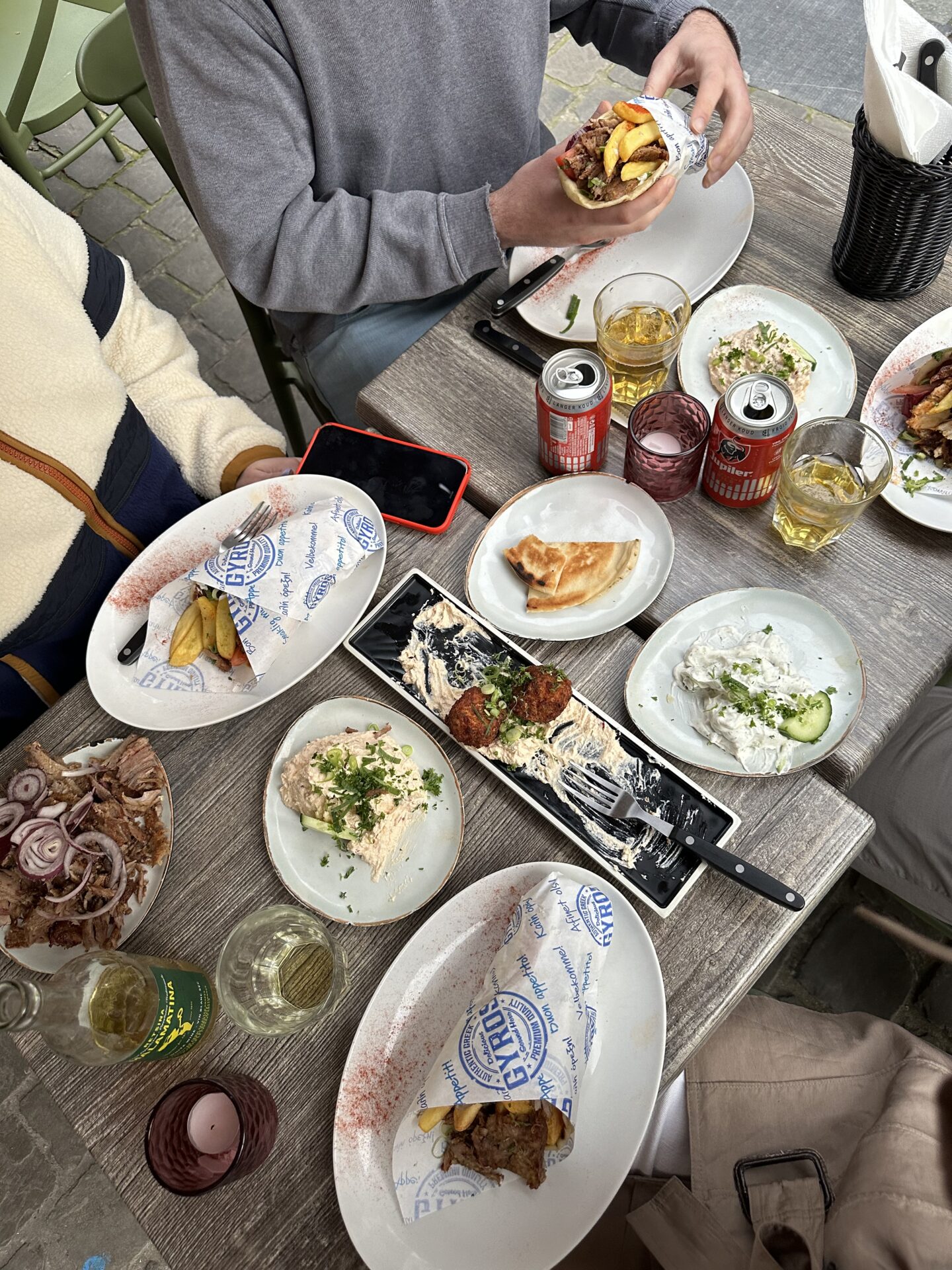 Birds Eye view of greek street food plated on table at souvlakeri in Antwerp belgium